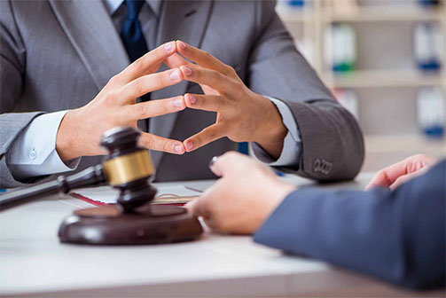 Client of a Fayetteville, NC school injury lawyer discussing a case over a desk